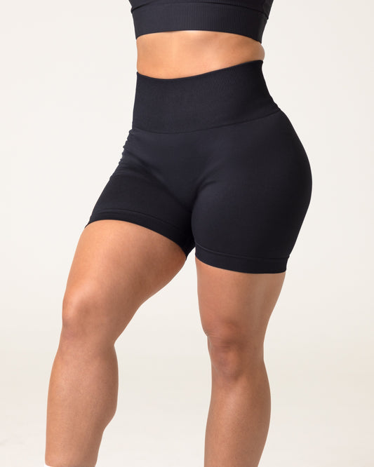 A millenial woman wearing scrunch butt shorts