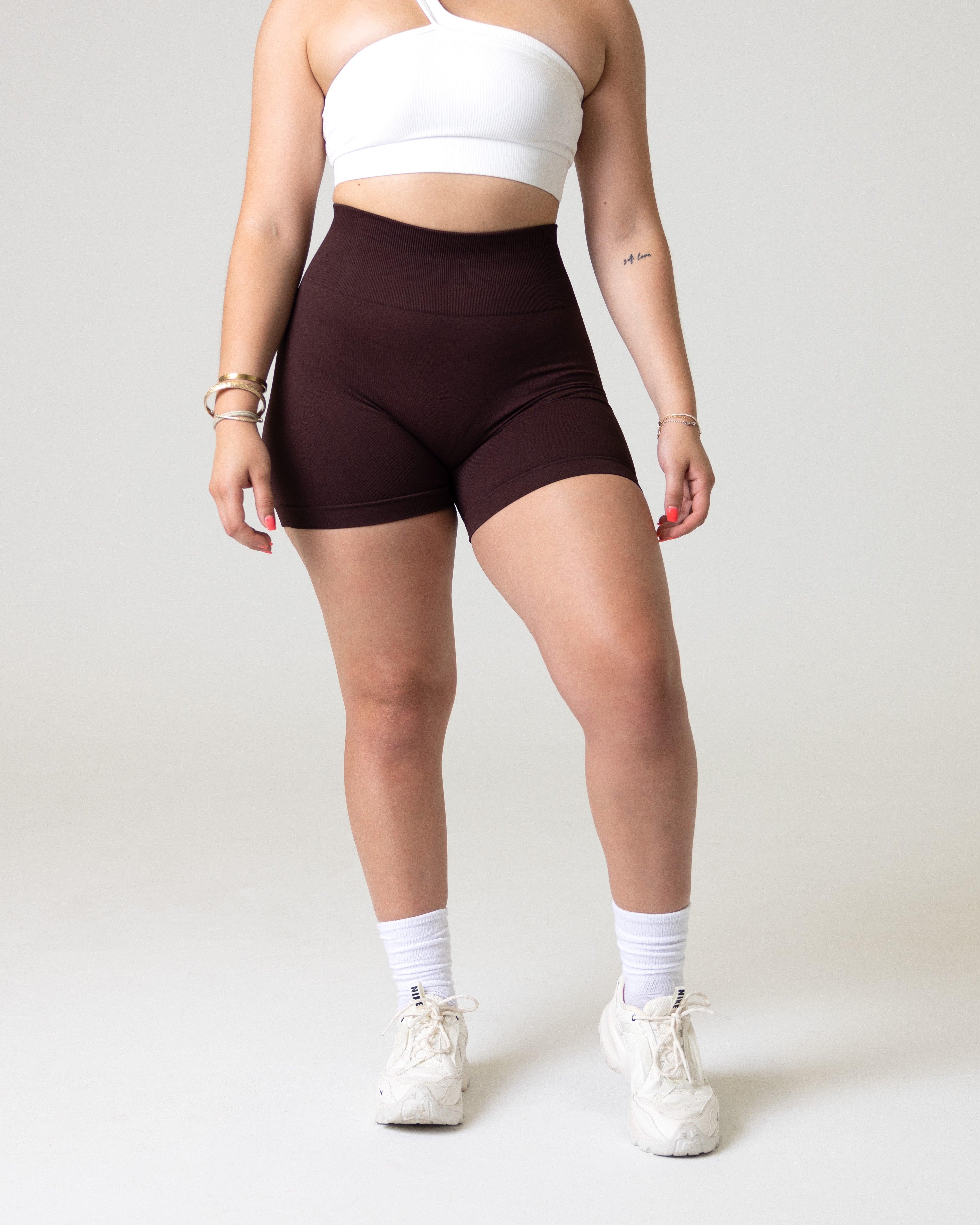 A woman wearing amplify seamless gym shorts