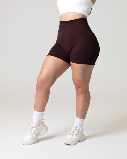 A woman wearing women's elevate seamless gym shorts - sportswear