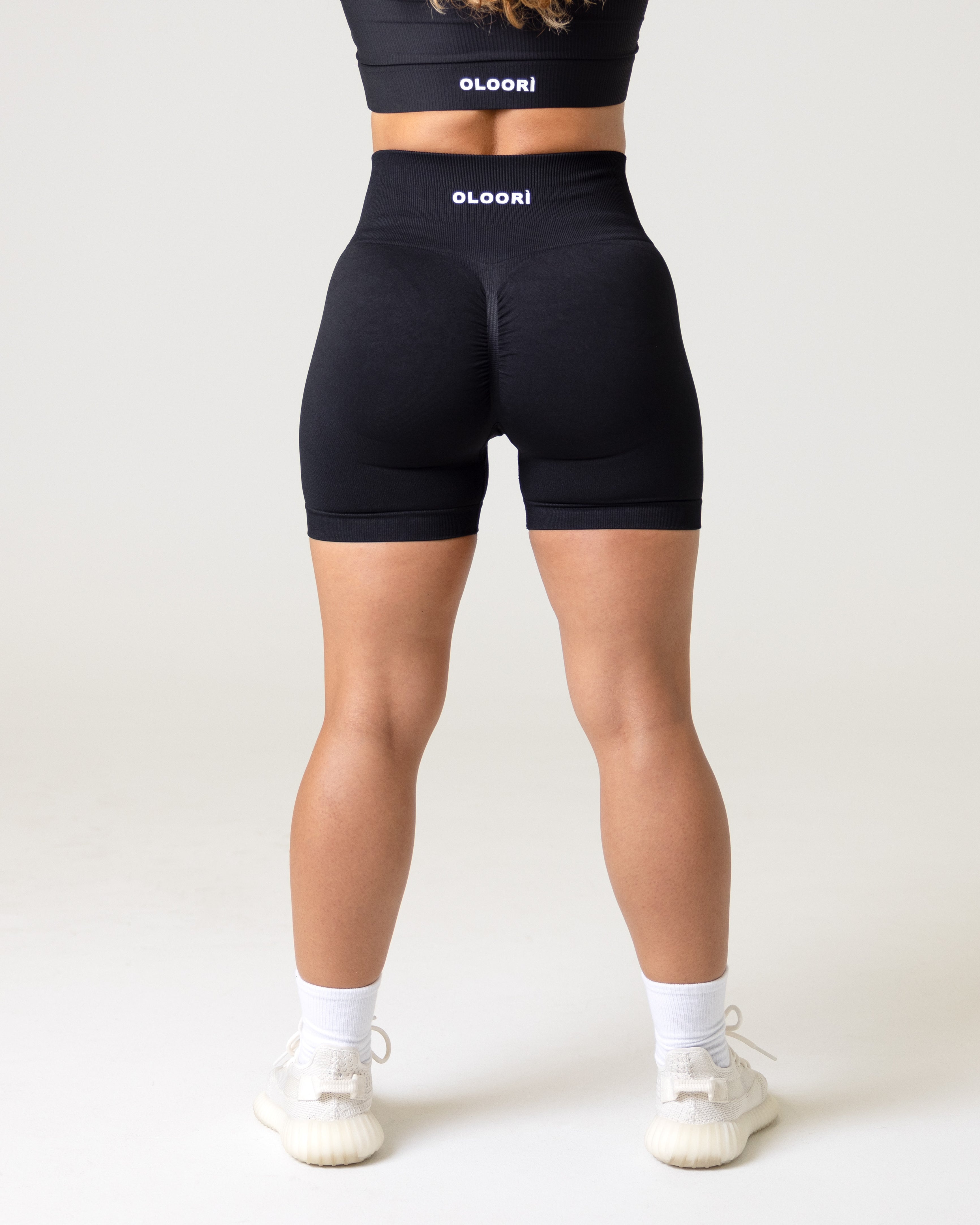 A women wearing black butt lifting workout shorts. Athletic Wear- Sportswear-Gymwear